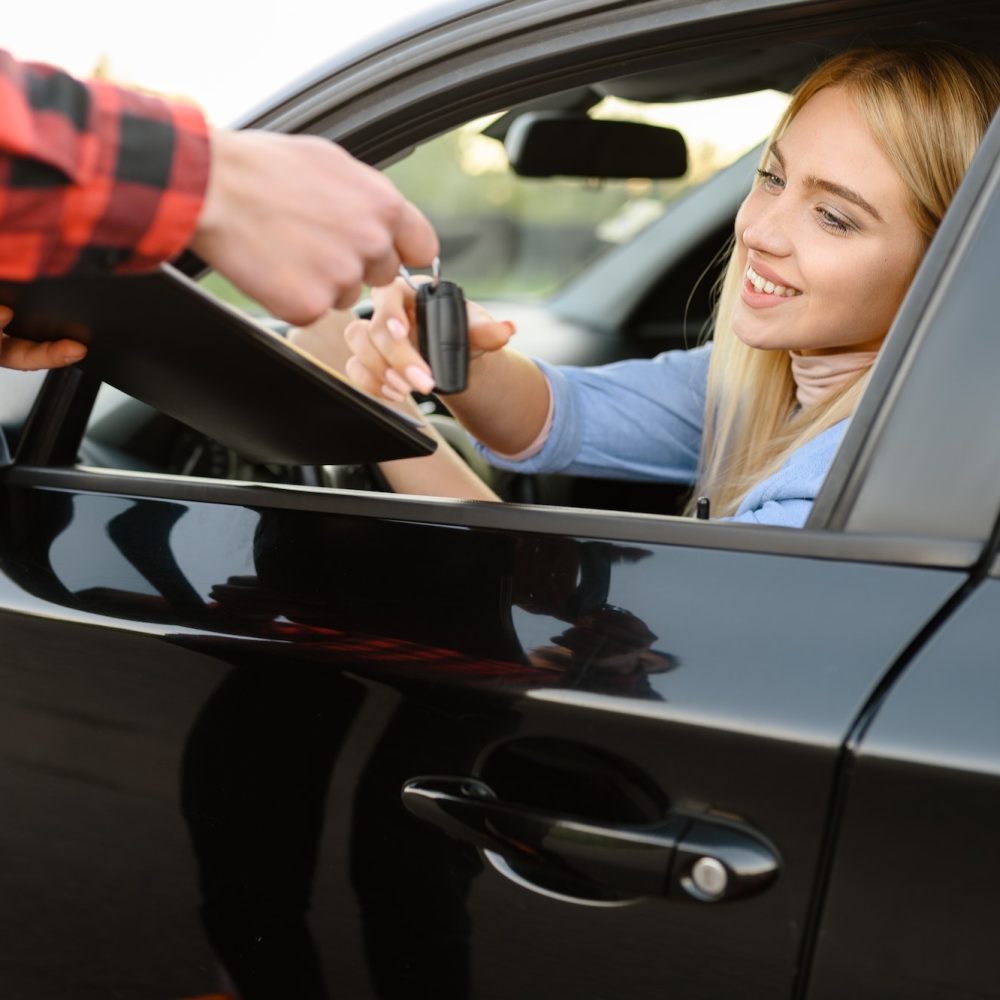 Instructor gives the keys to student in car, exam